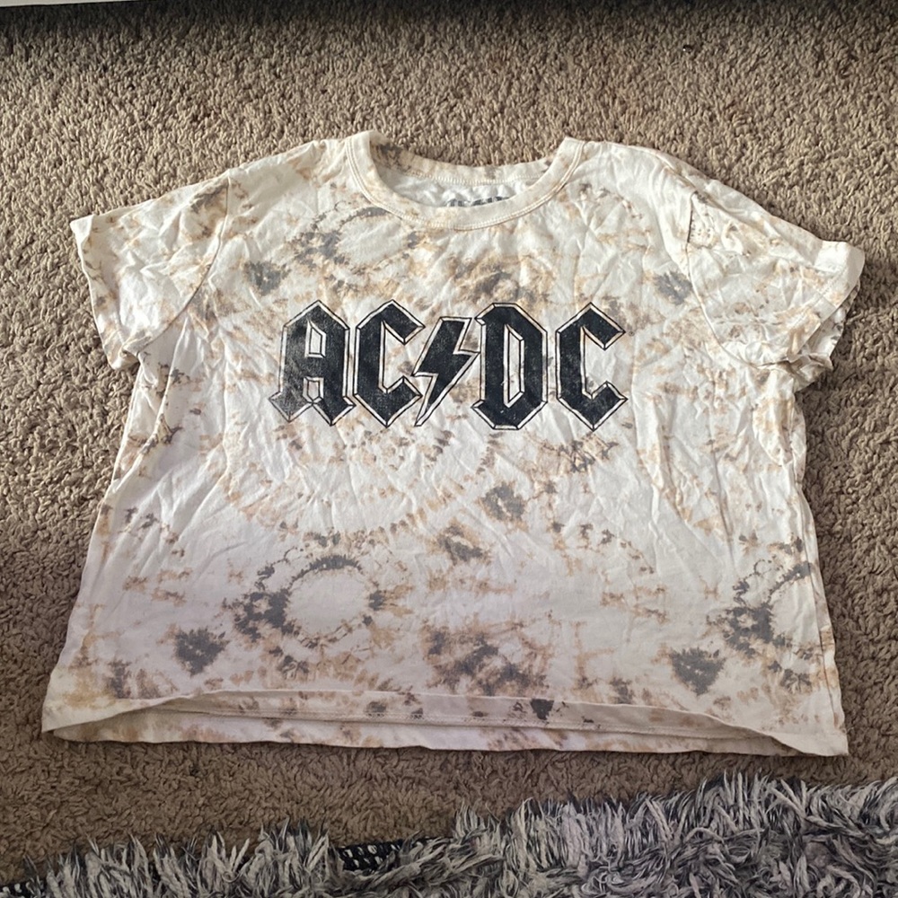 A tie-die shirt with a black font.